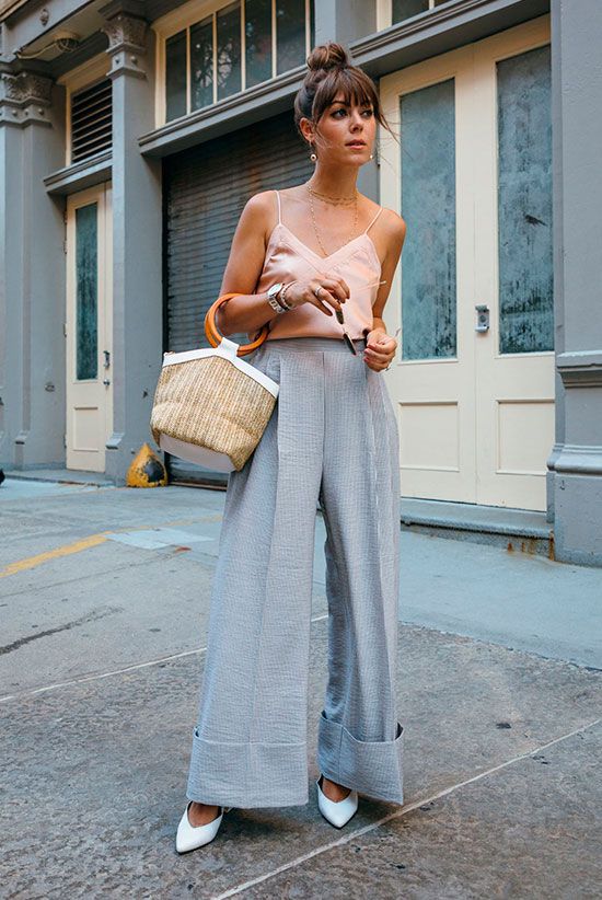 a blush silk spaghetti strap top, blue high wiasted wideleg pants, white shoes and a wicker bag