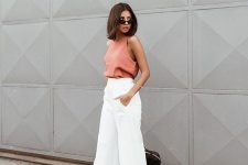 a coral halter neckline top, white palazzo pants and a black bag for a super bold look