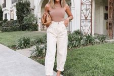 a dusty pink sleeveless top, creamy slouchy pants, tan mules and a brown clutch for work