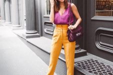 a hot pink linen tank top, high waisted yellow trousers, white shoes and a purple bag