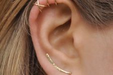 a lobe piercing with a long earring and stacked helix ones with hoop earrings for a minimalist look