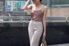 a mauve spaghetti strap top, neutral cropped pants, silver shoes and a brown bag for summer