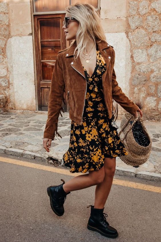a moody floral mini dress, black combat boots, a brown suede jacket with fringe on the sleeves