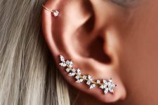 a refined floral and botanical gold and rhinestone climber earring and a matching ear cuff on the helix