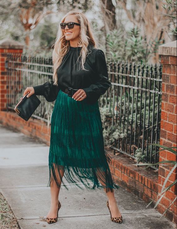 a special occasion outfit with a black blouse, an emerald fringe midi skirt, leopard shoes and a black clutch