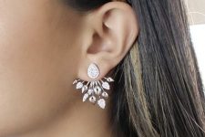 a statement ear jacket with a drop-shaped vintage stud and spiky detailing with crystals and without