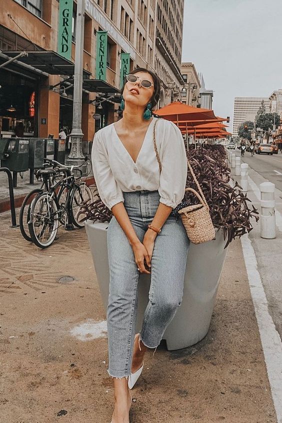 a white blouse with puff sleeves, blue high waisted jeans, white mules, a basket bag and statement earrings
