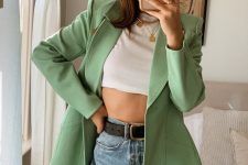 a white crop top, blue high waisted jeans, an apple green blazer and layered necklaces