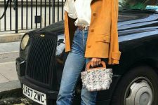 a white shirt, blue jeans, a yellow vintage jacket, black heels and a small and cute top handle bag