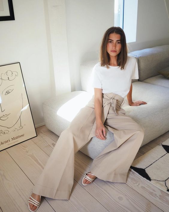 a white tee, tan high waisted wideleg pants, white strappy sandals for a minimal look