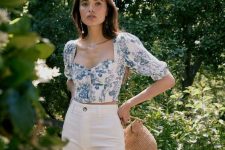 an elegant look with high waisted white jeans, a blue floral print crop top with puff sleeves and a basket