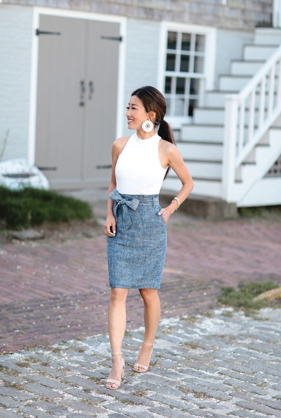 an elegant summer work look with a white halter top, a grey knee skirt, tan heels and statement earrings