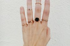 delicate gold rings stacked, a statement ring with a black rhinestone and gold midi rings that match