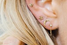 stacked lobe piercings and a helix one with mix and match gold stud earrings