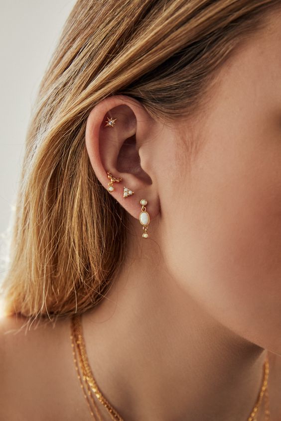 stacked lobe piercings with gorgeous gold and pearl earrings and a star stuf for the flat piercing