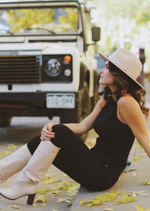 a black halter neckline top and skinnies, a tan hat and slouchy boots for the fall