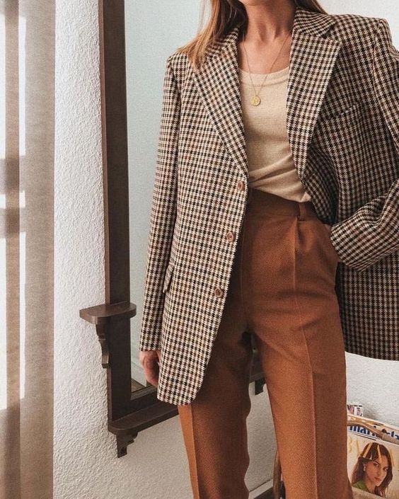 a tan top, an oversized plaid blazer, high waisted rust-colored pants for a comfy fall look
