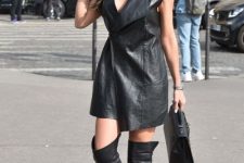 With black bag and black over the knee boots