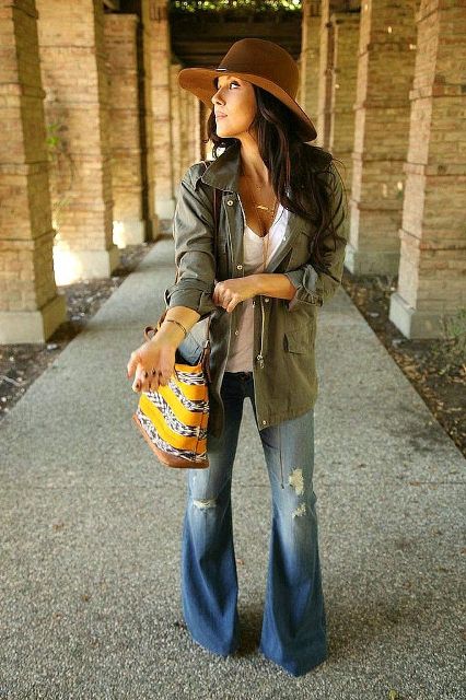 With brown hat, white t-shirt, olive green long jacket and printed bag