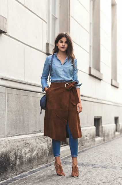 With denim shirt, skinny jeans, lace up high heels and blue bag