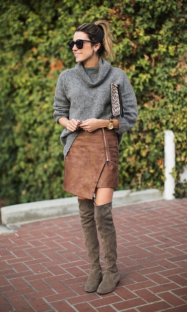 With gray loose sweater, printed clutch and suede over the knee boots