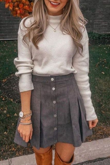 With gray sweater and brown high boots