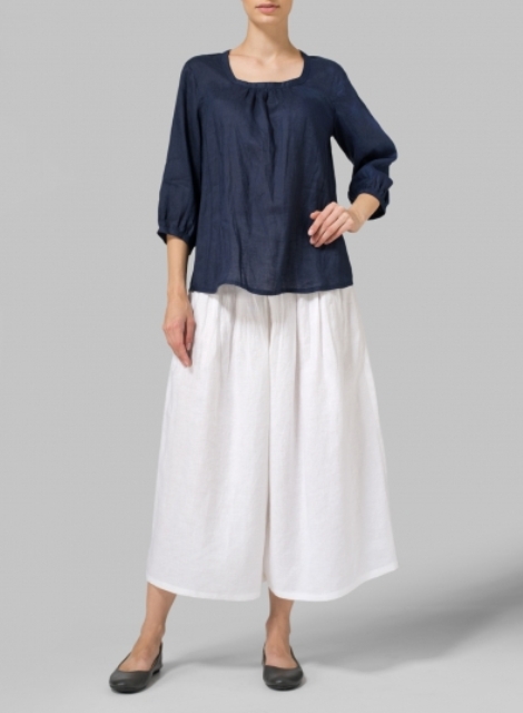 With white culottes and black flat shoes