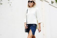With white loose sweatshirt, black bag and black lace up flat shoes