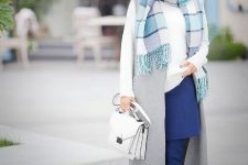 With white shirt, navy blue mini skirt, navy blue over the knee boots, white bag and gray long vest