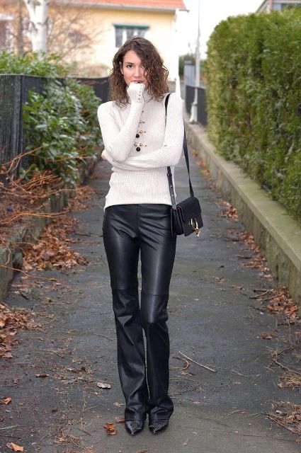 With white turtleneck, black mini bag and black boots