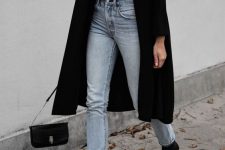 a basic fall outfit with a white tee, light blue jeans, black ankle booties, a black coat and a bag