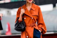 a beautiful rust-colored trench with white buttons is a cool bold touch to your fall look