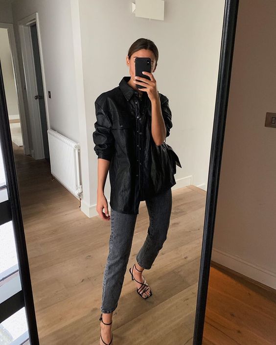 a black leather shirt, graphite grey cropped jeans, black strappy shoes with square toes