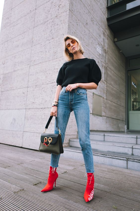 a black puff sleeve top, blue jeans, black pointed toe booties and a black bag for a wow effect
