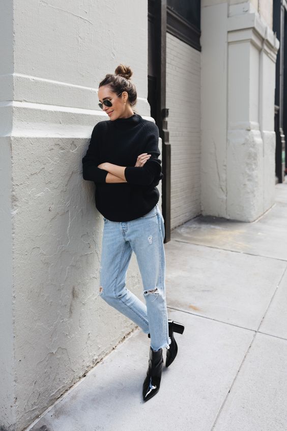 a black sweater, blue ripped jeans, black lacquer boots for a casual fall look