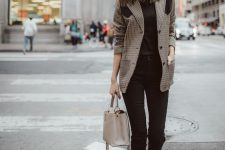 a black tee, black cropped jeans, black booties with zips accenting them and a creamy bag plus a two tone tweed blazer