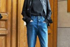 a black turtleneck, a black leather shirt, blue jeans and tan shoes for a comfy casual look