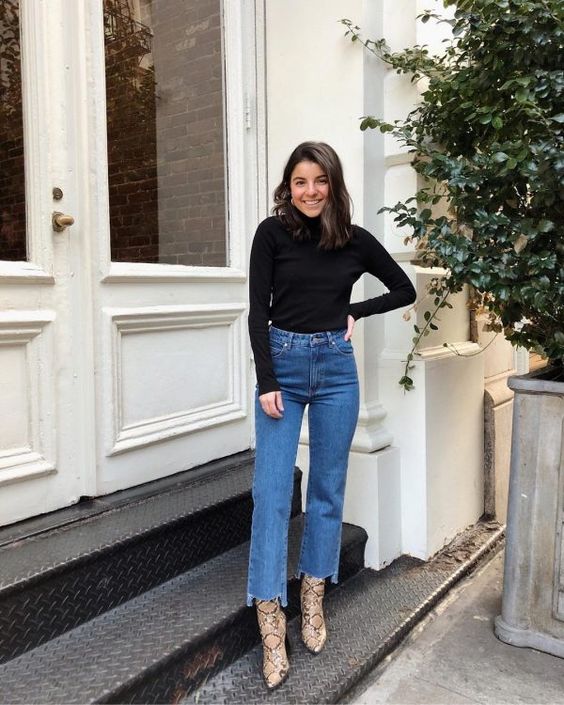 a black turtleneck, blue straight leg jeans, snakeskin booties for a simple and basic fall look