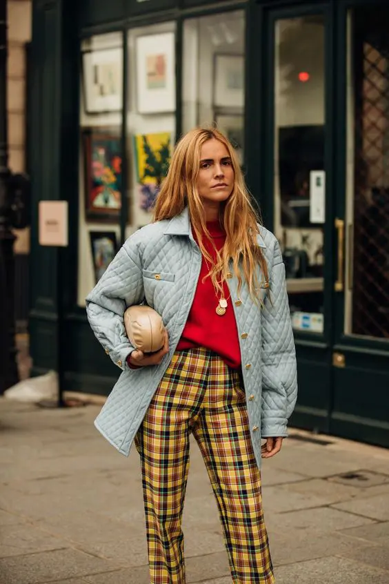 a colorful fall look with a red turtleneck, plaid pants, a powder blue quilted jacket and a clutch