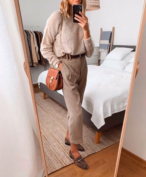 a comfy outfit with a tan top, tan pants, a brown belt, leopard shoes and a rust-colored bag