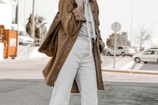 a grey hoodie, white straight leg jeans, white sneakers, a camel trench and a camel bag