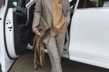 a grey plaid pantsuit, a tan turtleneck, apple green shoes and a chic printed bag