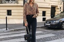 a leopard print shirt, black straight leg jeans, black shoes and a black crossbody for a bold look