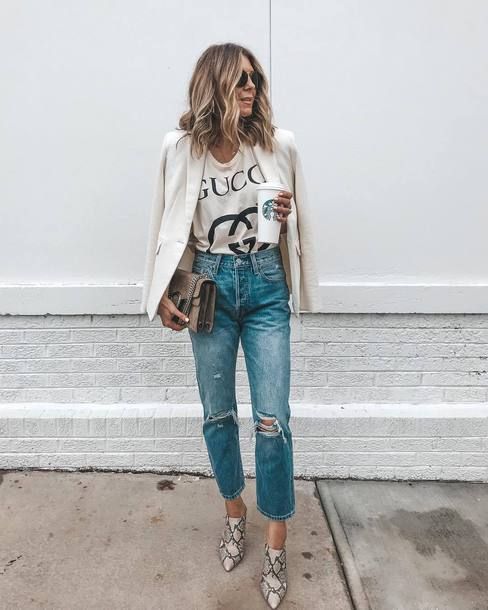 a printed light tee, blue ripped jeans, a white blazer, snakeskin print booties and a taupe bag