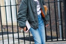 a printed tee, blue jeans, printed boots, a graphite grey bomber jacket