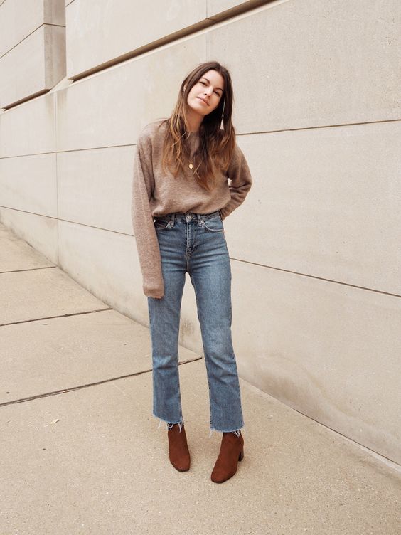 a simple and comfy fall look with a tan sweater, blue straight leg jeans and brown shoes square toe boots