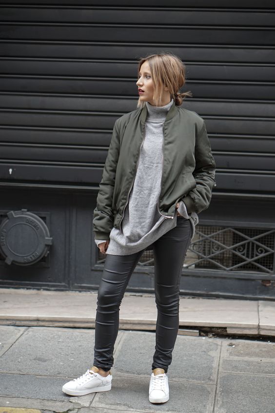 a simple look with an oversized grey turtleneck, grey leather pants, white sneakers and an olive green bomber jacket