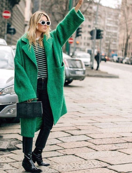 a striped top, black cropped jeans, black lacquer boots, an apple green oversized coat and a hunter green elegant bag