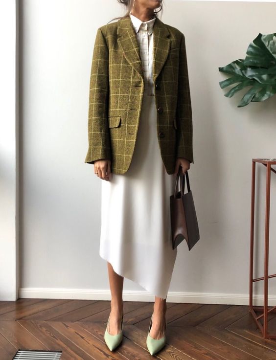 a stylish summer to fall outfit with a white printed shirt, an asymmetric white skirt, a green plaid blazer, green shoes and a burgundy bag
