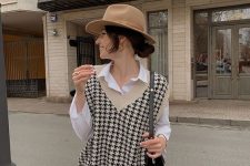 a white shirt, a printed knit vest, black shorts and a hat plus a bag to wear right now